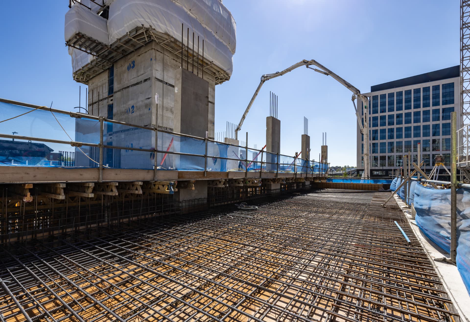 Concrete pump arm above reinforcement mesh on a city centre slab pour